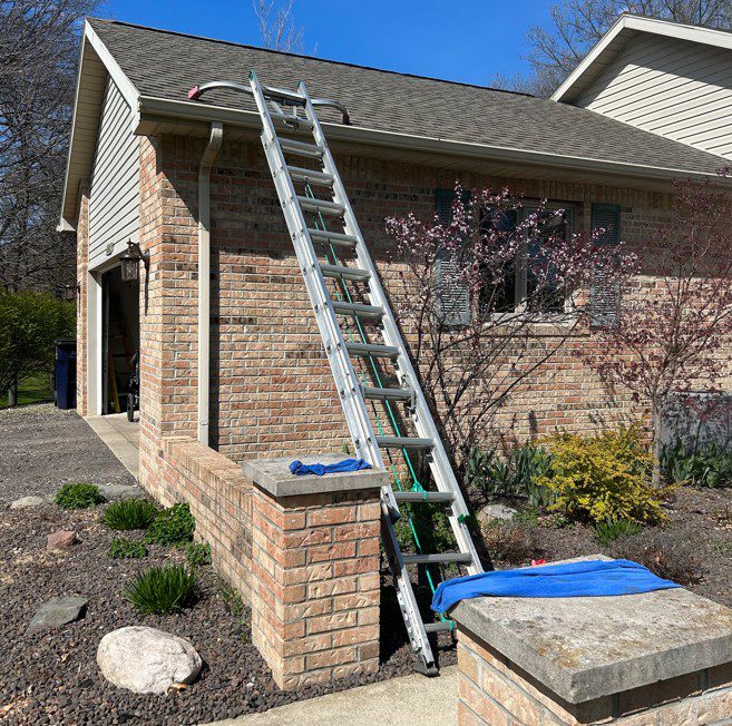 an image that represents gutter cleaning with ladder